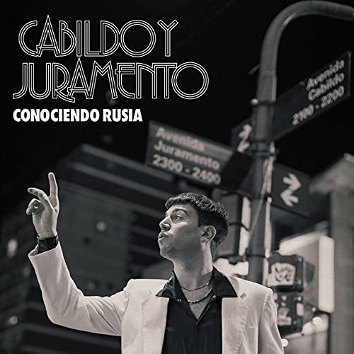 Vinyl album cover featuring a man looking up at a city street.