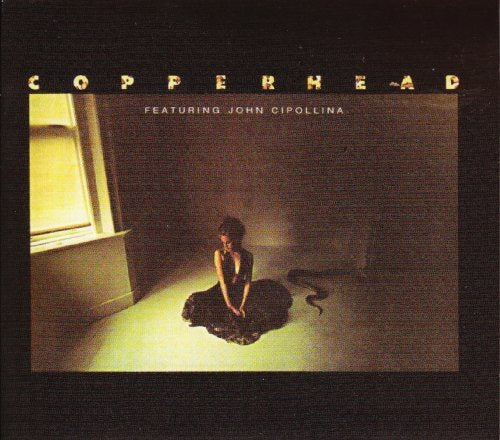Album cover featuring a woman kneeling with a snake, surrounded by dark room.
