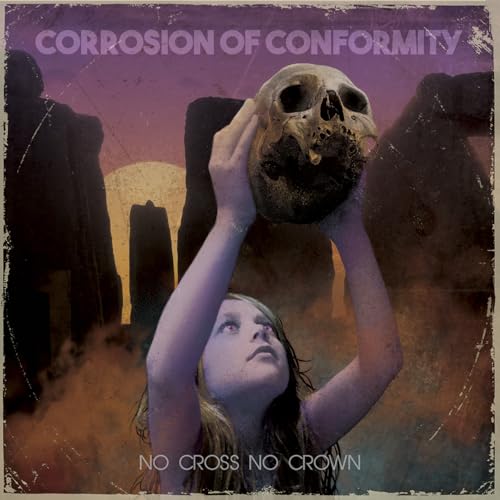 A girl holds a skull above her head against a backdrop of stone monoliths.