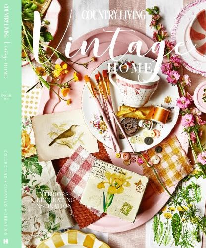 A flat lay of a teacup, paintbrushes, postcards, and flowers on a pink tray.