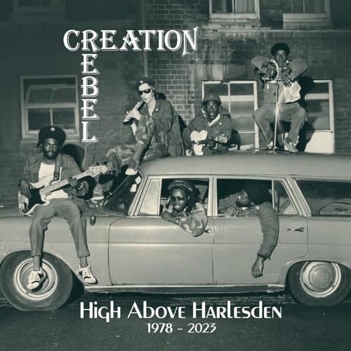 CD cover featuring a band with instruments posing around a vintage station wagon.
