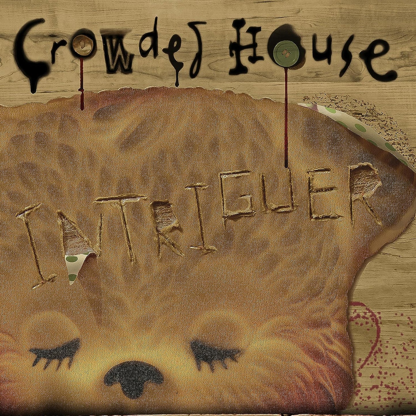 Crowded House "Intriguer" CD cover: brown textured background with carved letters.
