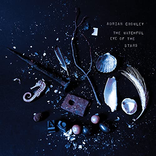 CD cover with scattered shells, feathers, and small objects on dark blue.