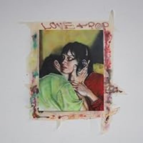 Polaroid-style photo of a couple embracing, with painted border text.