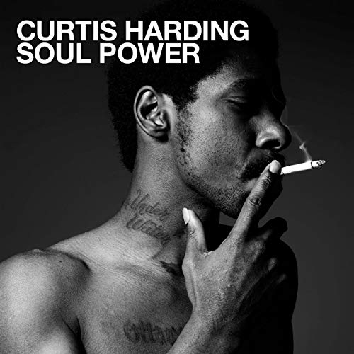 Black and white portrait of Curtis Harding smoking a cigarette.