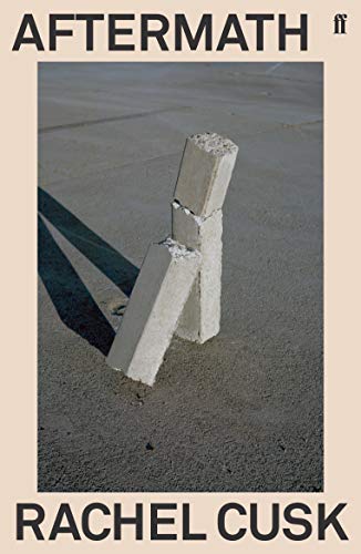 Book cover titled Aftermath by Rachel Cusk showing broken concrete pillars on a sandy surface.