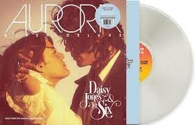 Daisy Jones & The Six" vinyl record with couple's portrait and white disc.