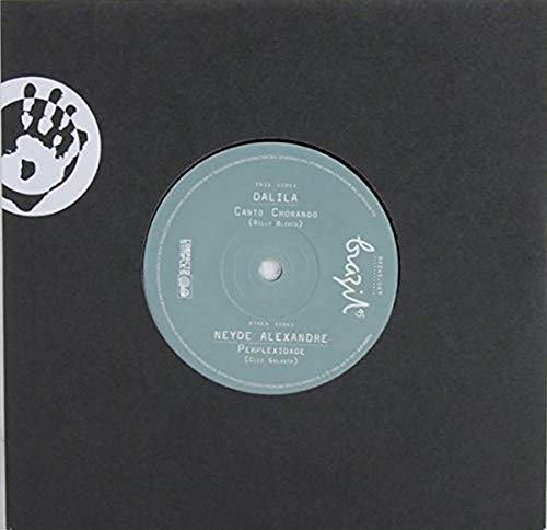 A 7-inch vinyl record label in light blue centered on a black square sleeve.