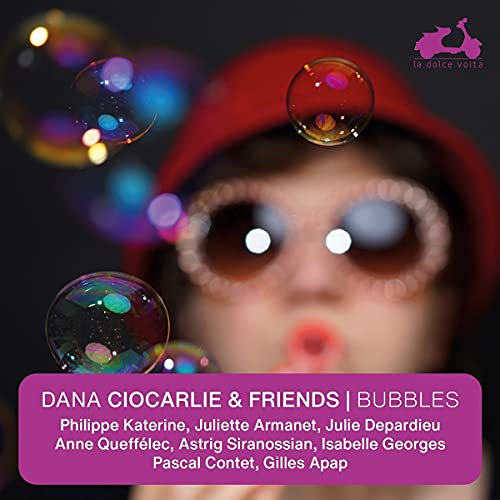 CD cover: woman in red hat blowing iridescent bubbles.