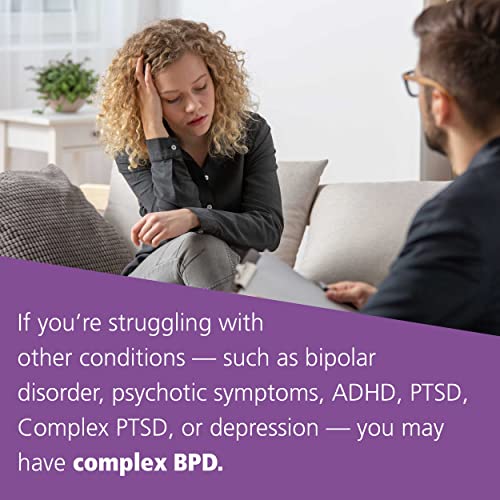 A curly-haired woman sits on a sofa talking to a therapist in a session.