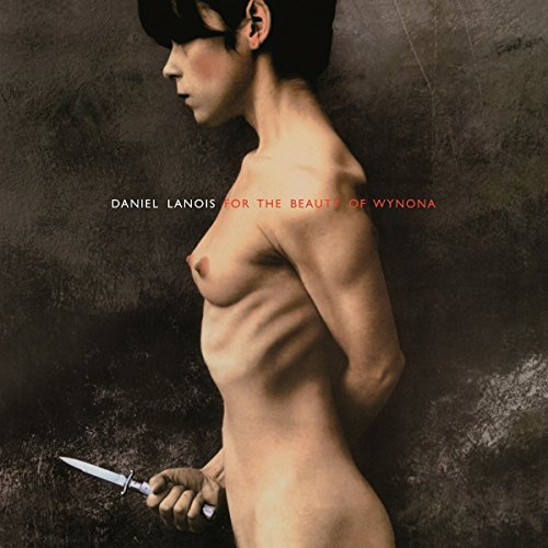 Vinyl album cover featuring a nude woman holding a knife against a dark background.