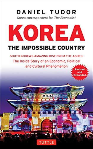 Book cover of Korea: The Impossible Country featuring a colorful, illuminated historic gate.