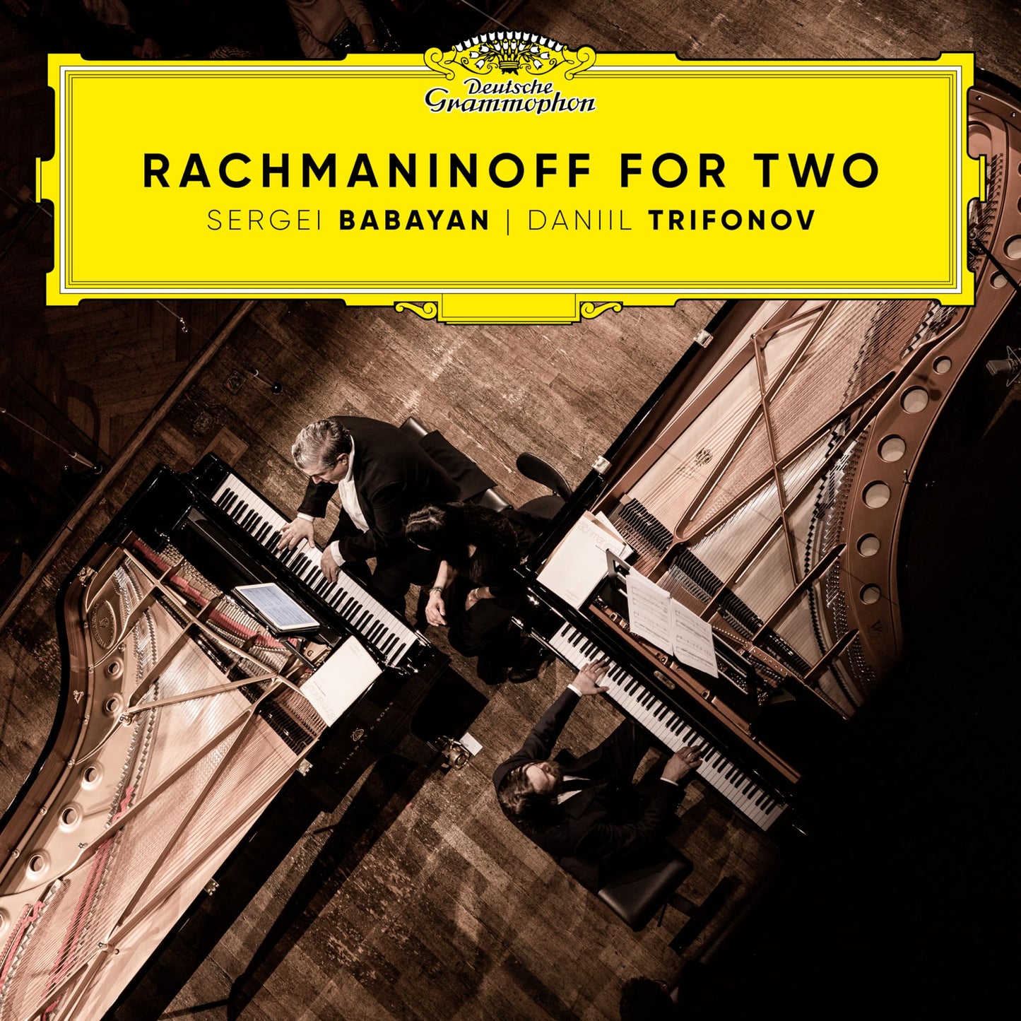 CD cover: Two pianists at grand pianos, yellow and gold design.