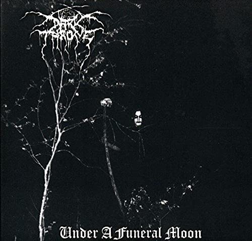 Black and white album cover featuring a corpse-painted figure in a dark forest.