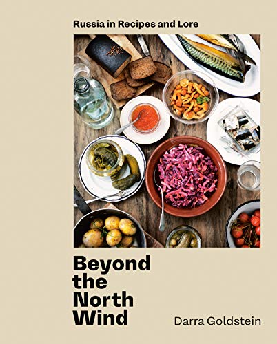 Cookbook cover with Russian food, including fish, pickles, and red cabbage.