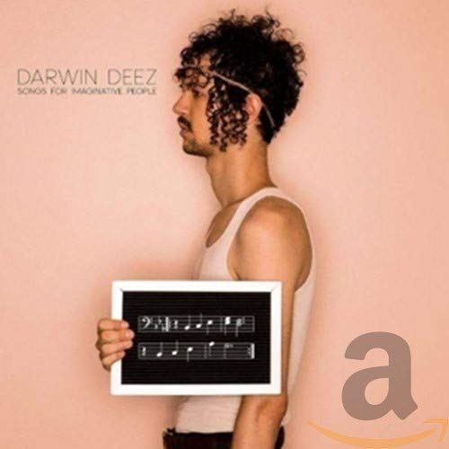 Darwin Deez album cover: man holding sheet music against a pink background.