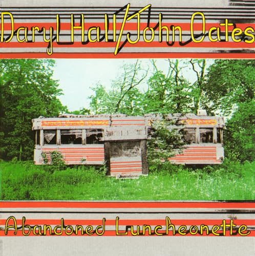 Album cover showing an abandoned diner in a grassy field with trees behind it.
