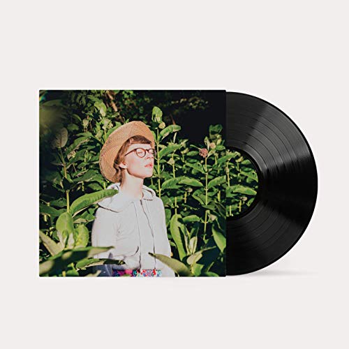 Vinyl record with album art featuring a woman in a straw hat.