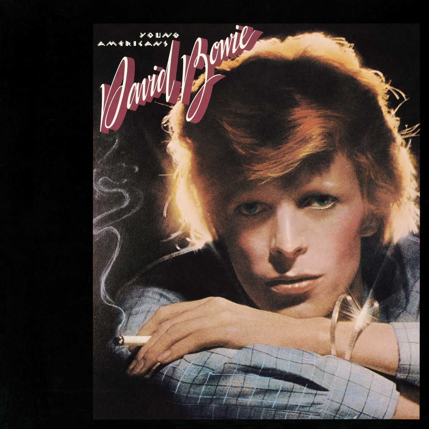 Close-up portrait of David Bowie holding a cigarette on the Young Americans album cover.