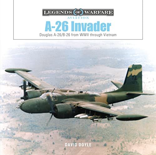 A-26 Invader aircraft in flight over a mountainous landscape.