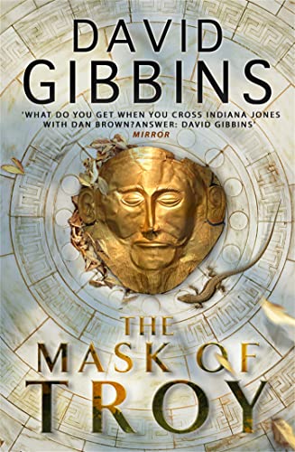 Book cover featuring a golden mask, lizard, and ornate circular design.