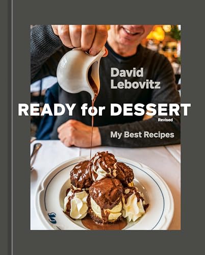 Baking book cover with chocolate dessert and a person pouring sauce.