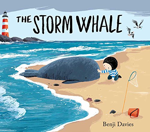 A child in a striped shirt touches a beached whale on a sandy shore.