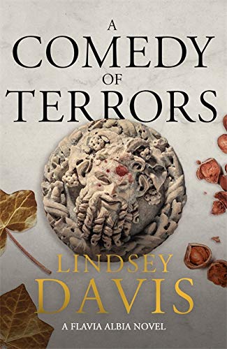 Book cover: "A Comedy of Terrors" with a stone face and autumn leaves.