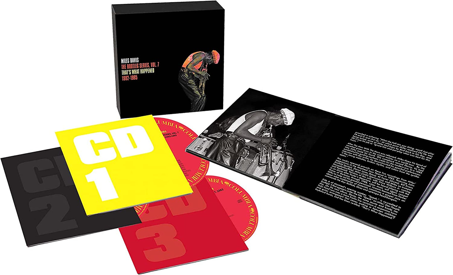 Music album set with CDs and book on white background.