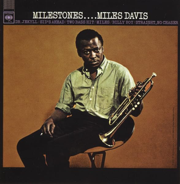 Miles Davis portrait on album cover, holding a trumpet, brown background.