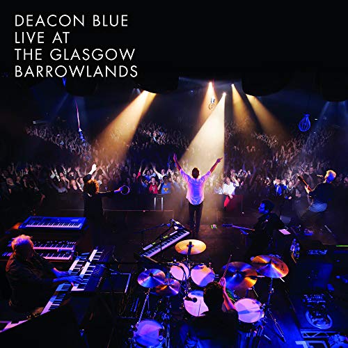 Deacon Blue performing live on stage before a large, cheering crowd at Glasgow Barrowlands.