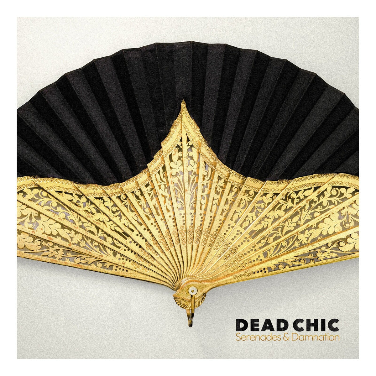 Ornate gold fan spread against a textured gray background, album art.