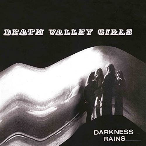 Black and white album cover featuring a band silhouette against a distorted light background.