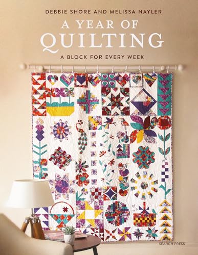 Book cover featuring a colorful patchwork quilt hanging on a wall behind a lamp.