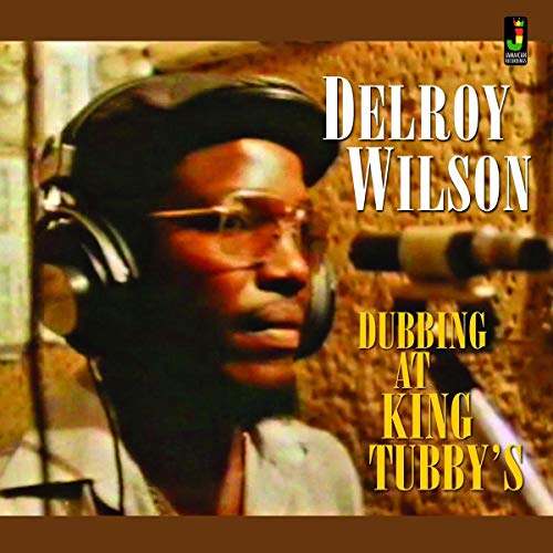 Delroy Wilson portrait on album cover, wearing headphones and glasses.