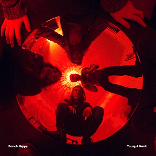 Red-toned album cover with four people around a central light source.