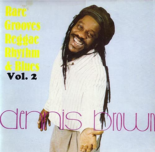 CD cover featuring Dennis Brown, a reggae musician with dreadlocks.