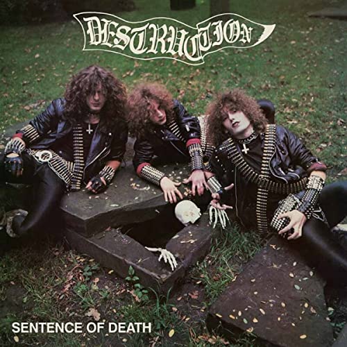 Destruction album cover: three metal musicians posed in a graveyard.