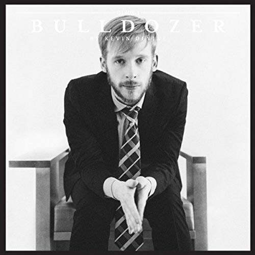 Black and white album cover featuring a man in a suit sitting on a chair.