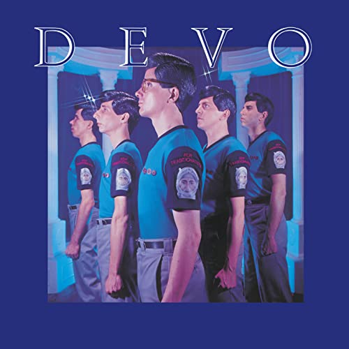 Devo band members in blue uniforms stand in front of a blue backdrop.