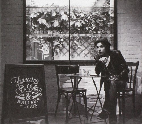 Black and white photo of Francesco Di Bella seated at a cafe.