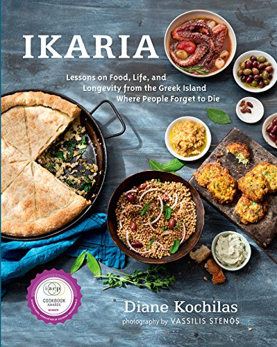Cookbook cover with various Greek dishes on a blue-gray surface.