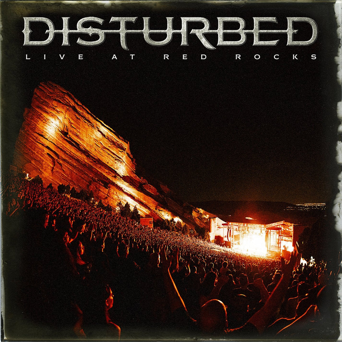Disturbed live album cover featuring Red Rocks Amphitheatre and a concert crowd.