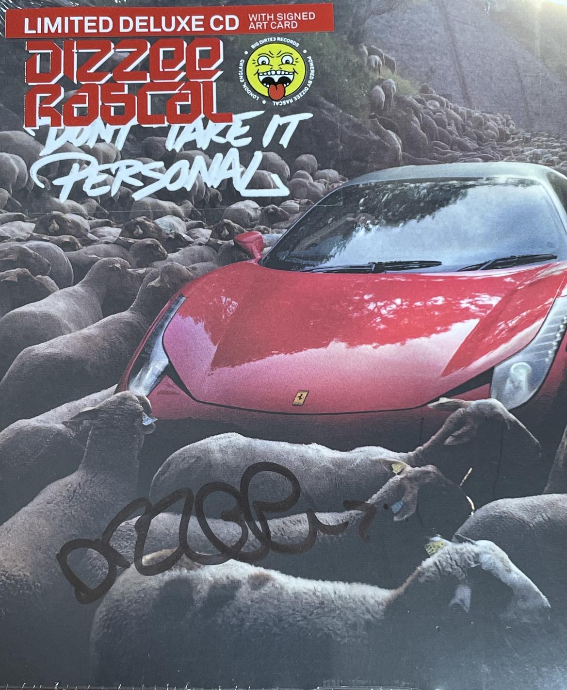 Dizzee Rascal album cover: red car amidst a crowd of sheep, signed.