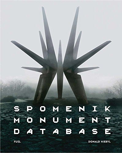 Book cover featuring a large, abstract, spiky metal monument in a foggy, rocky landscape.