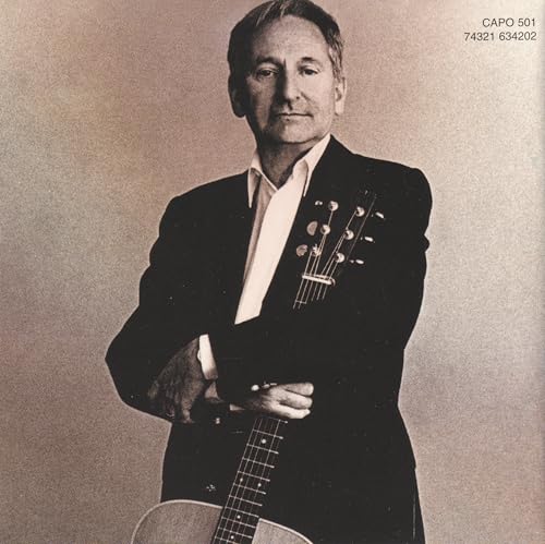 Lonnie Donegan holding a guitar, black and white portrait.