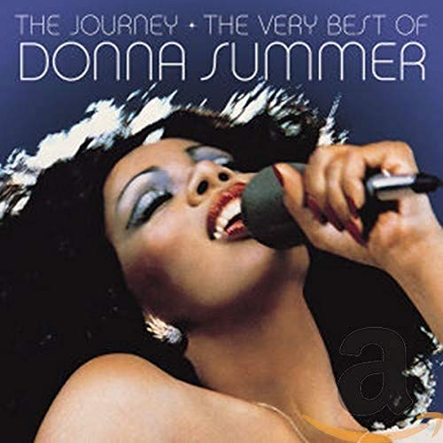 Donna Summer singing into a microphone on the cover of her greatest hits album.