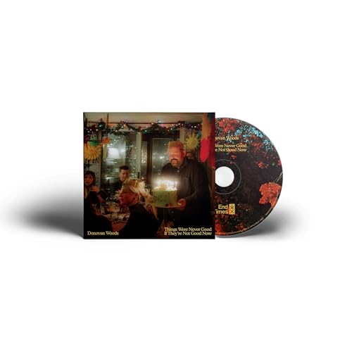 Donovan Woods CD cover featuring a dimly lit indoor scene with people.