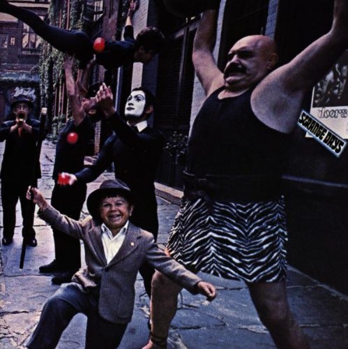 Album cover for The Doors’ “Strange Days” featuring performers in a street.