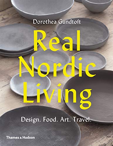 Book cover with gray plates and yellow text: "Real Nordic Living.